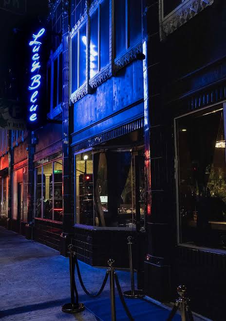 Lucy Blue neon sign at night
